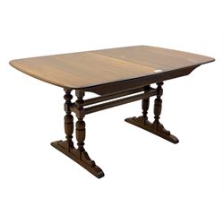 Ercol - late 20th century oak refectory dining table, rectangular top with rounded corners and central extending leaf, raised on turned baluster supports united by a stretcher (Extended 200cm)