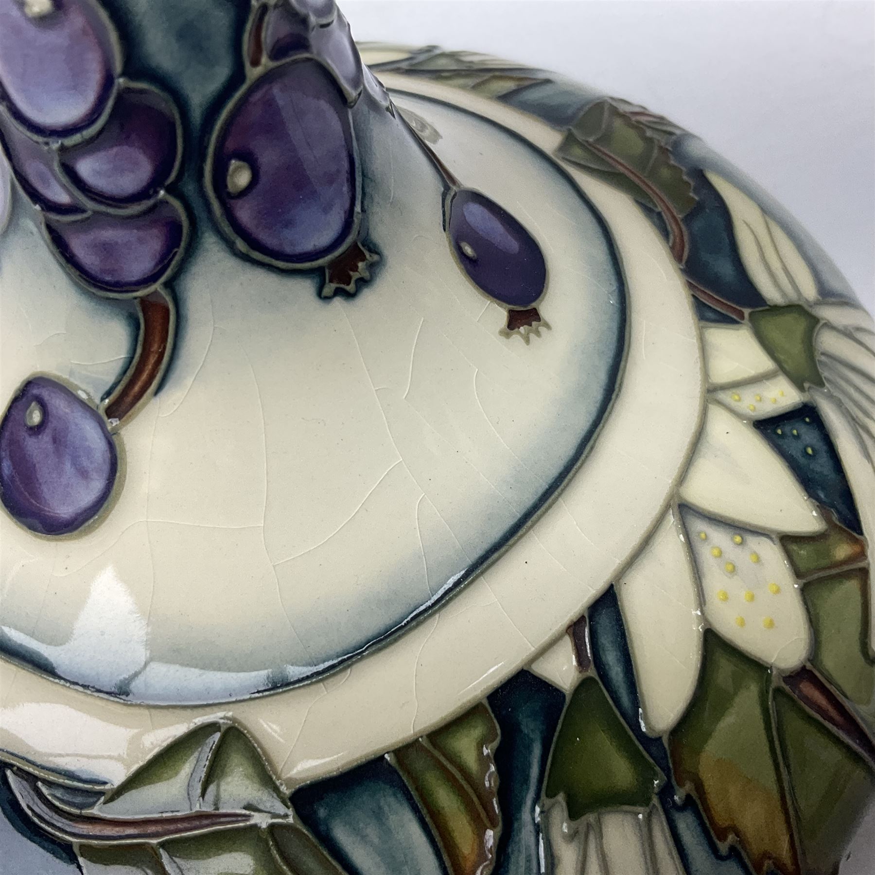 Moorcroft vase, of compressed form with a tall flared neck, decorated in the Juneberry pattern, circa 2000, H25cm