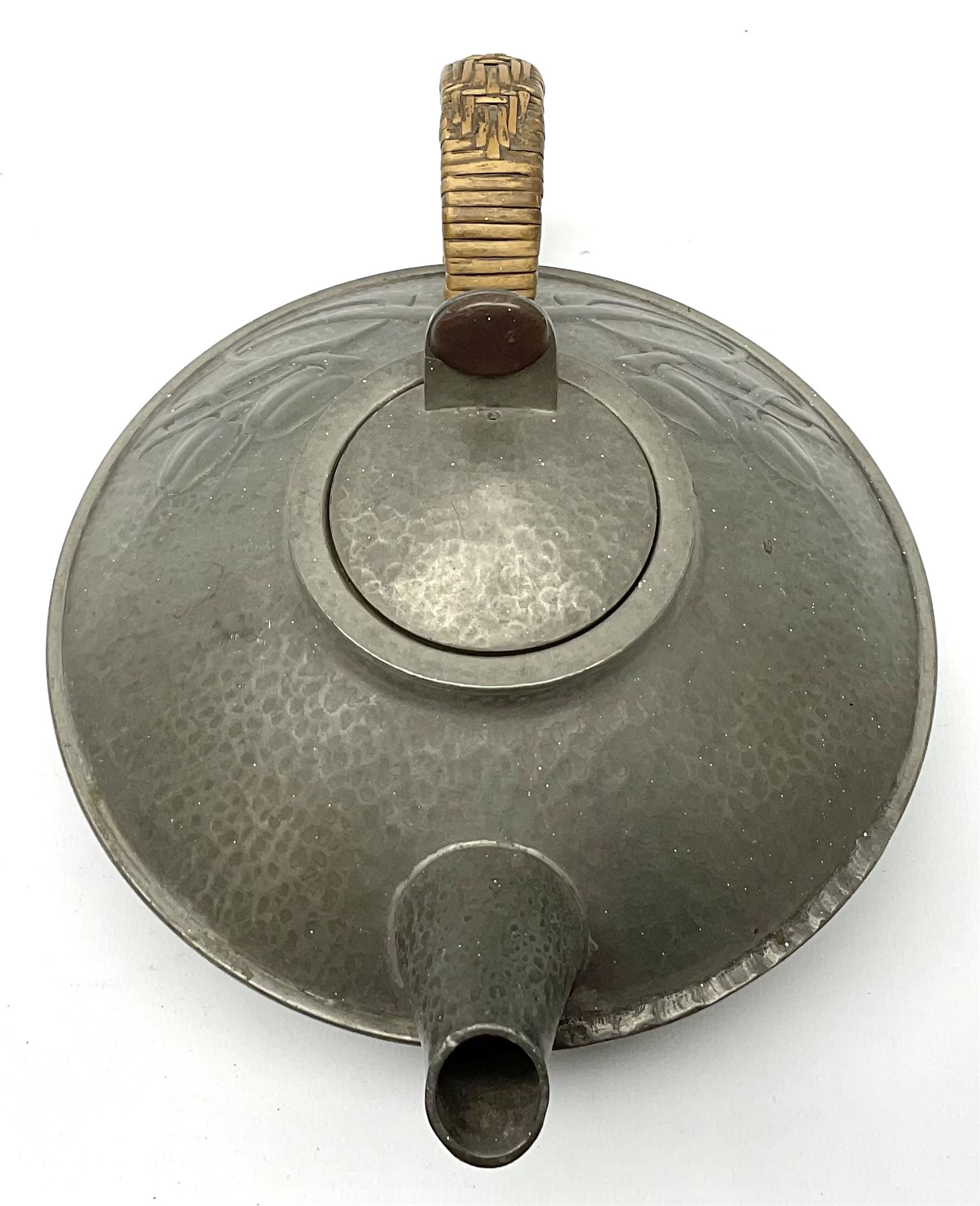 Archibald Knox for Liberty & Co Tudric pewter three piece tea service, comprising teapot with woven reed handle, single handled open sucrier, and milk jug, each with planished finish and detailed with honesty flowers, each impressed beneath Made in England Tudri Pewter 0231 