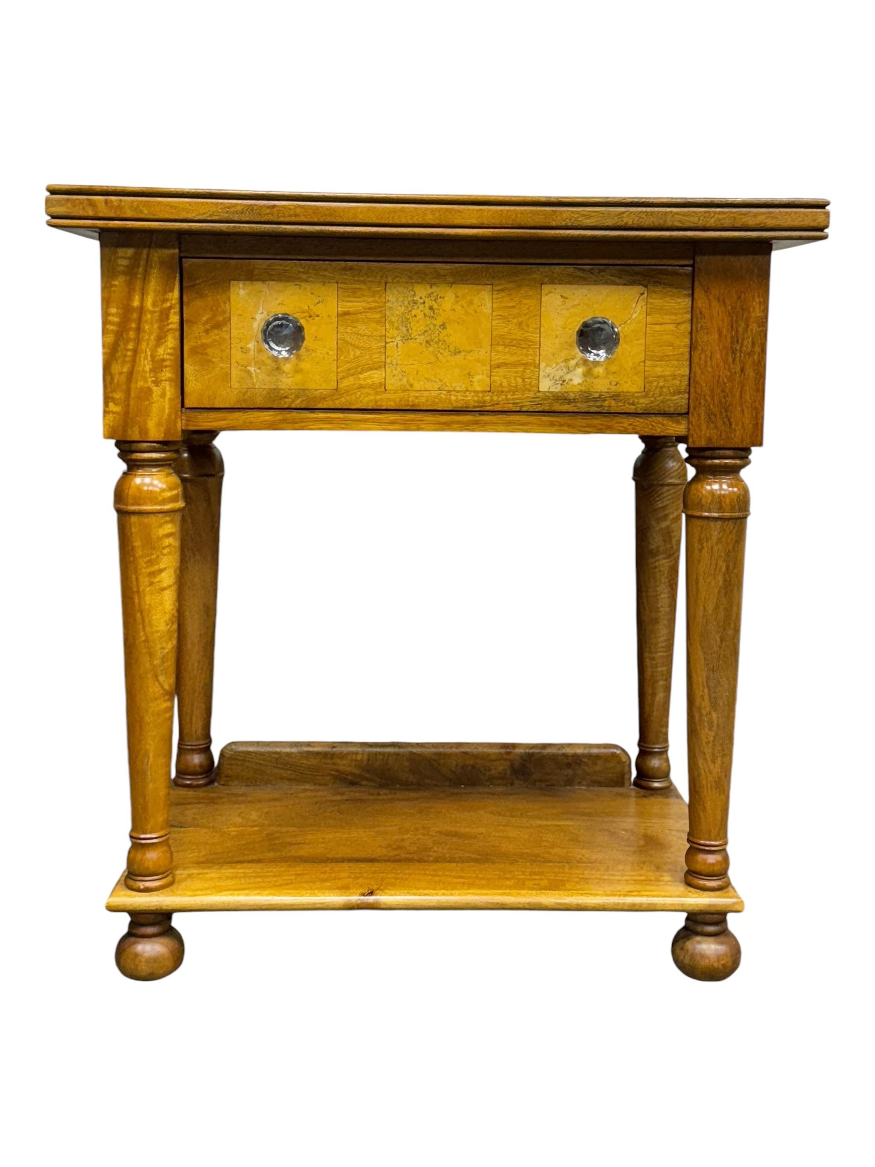 Barker and Stonehouse -  contemporary 'Flagstone' side table, rectangular crossbanded top with central diamond inlay, over single frieze drawer with faceted glass pulls, turned columns and undertier shelf, raised on bun feet