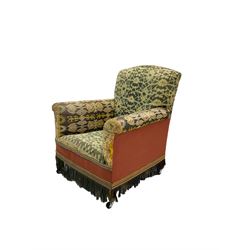 Early 20th century armchair, upholstered in green patterned fabric with sprung seat and fringe, raised on tapered supports with castors