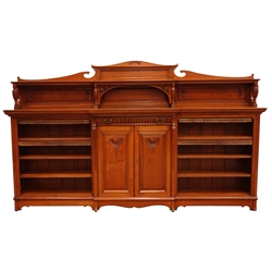  Large late Victorian walnut breakfront low bookcase, raised shelved back with scroll cresting above a single lobed drawer stamped Lamb Manchester, two central panel doors enclosed by reeded scroll columns, shaped apron and feet, W294cm, H177cm, D43cm  