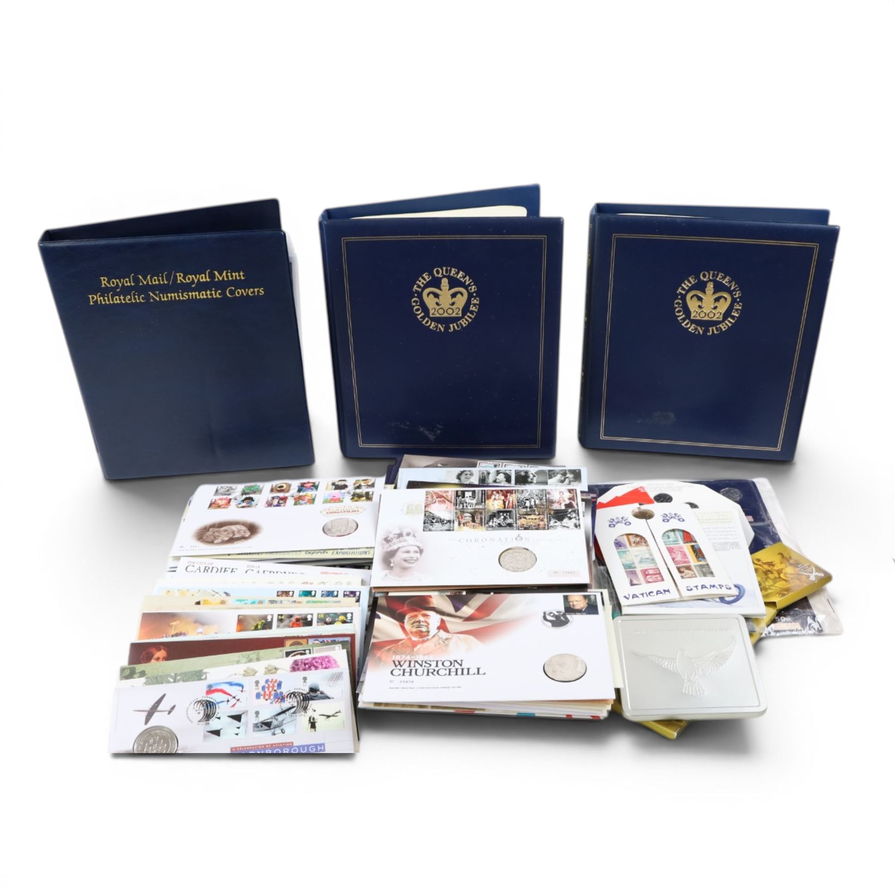 Approximately 104 Royal Mail Royal Mint coin or medallion covers, housed in an official Royal Mail Royal Mint ring binder folder and loose, together with The Queen's Golden Jubilee Coin Cover Collection in two albums, commemorative fifty pences, crowns, etc