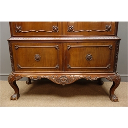  Early 20th century mahogany Chippendale style cabinet, carved swan neck pediment above blind fretwork frieze and acanthus carved moulding, two doors enclosing three shelves and a bank of nine drawers with fitted cutlery inserts, below two doors enclosing  shelf, scroll carved apron, cabriole legs with ball and claw feet, W126cm, H208cm  