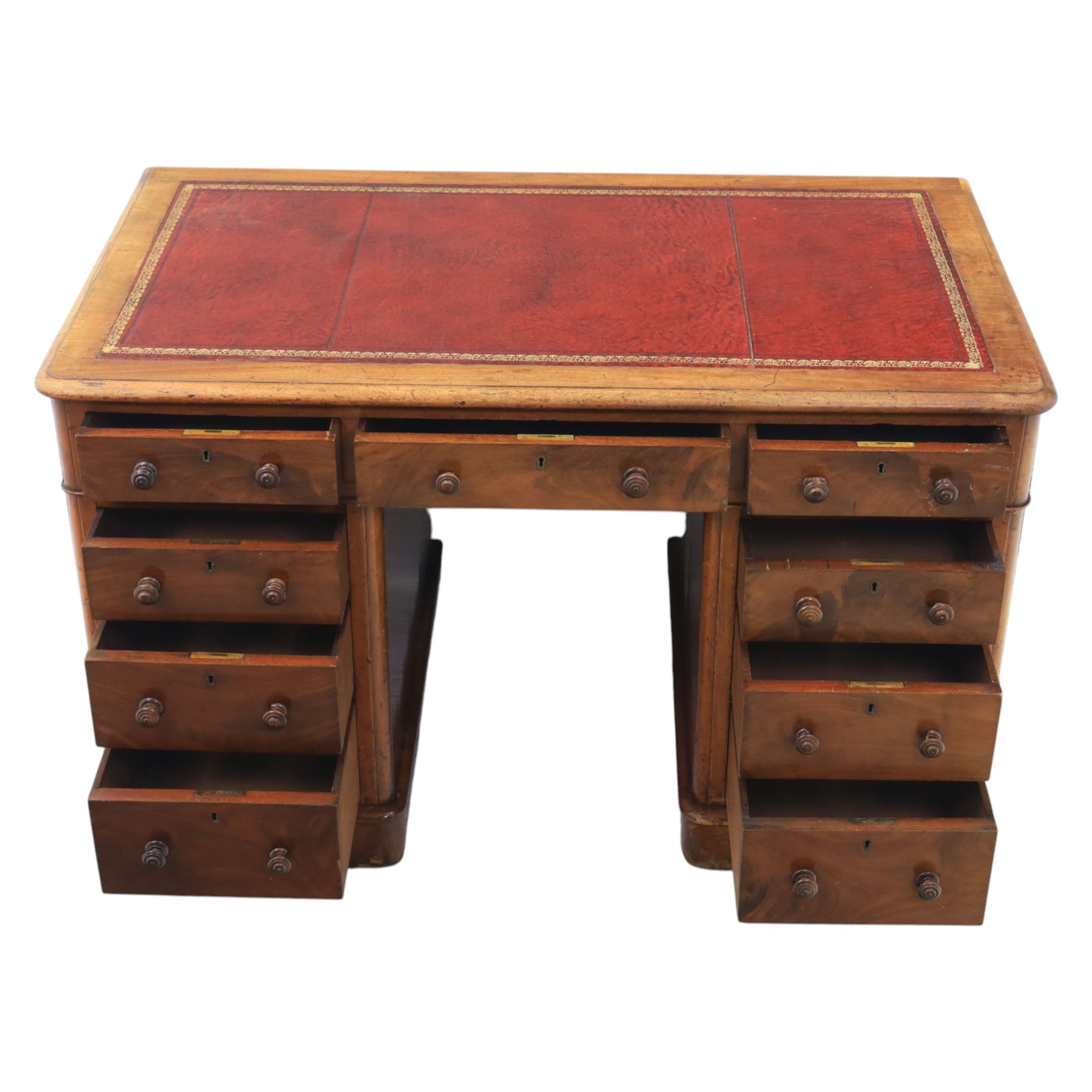 Victorian mahogany writing desk, featuring inset tooled red leather top, raised on two pedestals, nine drawers with figured veneer fronts