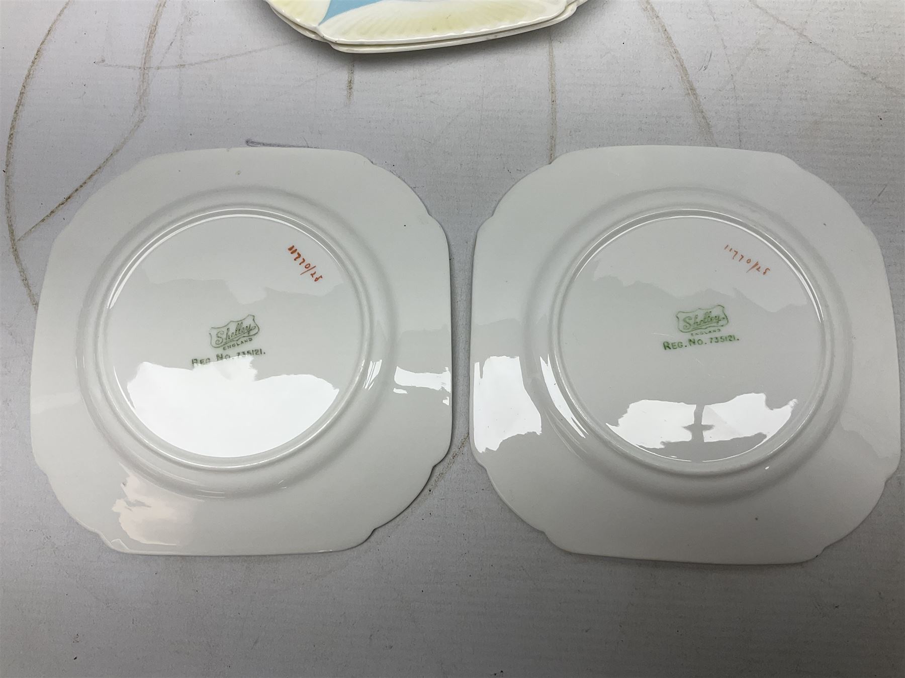 Shelley Dainty pattern tea wares, of lobed form with blue star decoration on merging white and yellow ground, comprising five teacups, five saucers, six tea plates, milk jug and cake plate, all with printed green mark beneath, some with painted pattern no 11770