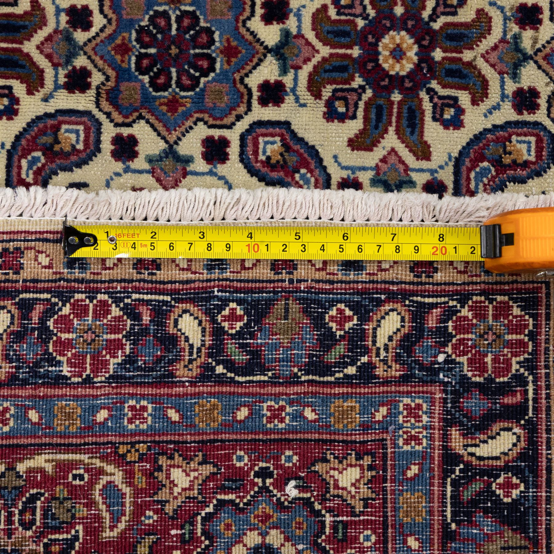 North West Persian Tabriz hand-knotted carpet, ivory field densely decorated with an all-over Herati style (Mahi) lattice composed of stylized rosettes and scrolling leaves, enclosed by a broad madder-red border of palmette and floral vine design, between navy guard stripes, cotton fringe ends 