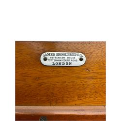 James Shoolbred & Co. London - Edwardian inlaid mahogany triple combination wardrobe, projecting dentil cornice over bevel glazed door, two figured oval panelled doors and four drawers, the central compartment fitted with linen slides and drawers, satinwood banding, on base with shaped apron and bracket feet, with enamel plaque 