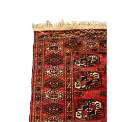 Bokhara red ground rug, decorated with two rows of Gul motifs, the border with geometric guard bands decorated with stylised plant motifs