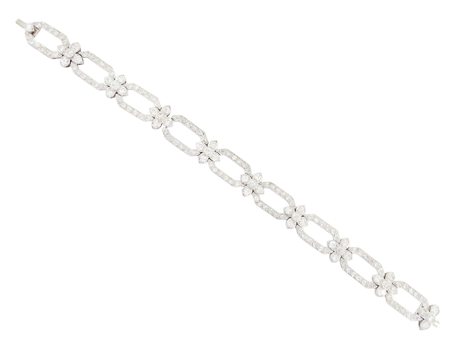18ct white gold and platinum, milgrain set old cut diamond flower head and openwork panel link bracelet, total diamond weight approx 4.25 carat