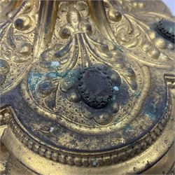 20th century gilt metal monstrance, in the Gothic revival style, with glazed aperture to centre surrounded with clear paste stones, in a pierced floral and scroll border set with coloured paste stones, within a sunburst surround, on a paste set knopped stem and similar foliate foot, H59.3cm