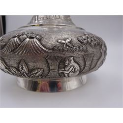 20th century Indian silver mounted decanter, with repousse and chased decoration to body depicting agricultural scenes, upon circular foot, with integral glass liner and cylindrical stopper, stamped Sterling to base, H24.5cm