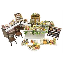 Collection of miniature dolls house grocery shop furniture and produce, comprising glazed corner counter with brass style cash register, shelved preserves unit, pies, cheese board and trays of meats, pair of white cheese counters, biscuit display with six tins, glazed preserves cabinet, pair of shop chairs and four further cheese boards complete with grapes and label flags