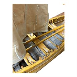 Wooden model of a fishing coble, with single canvas sail, upon a rectangular wooden plinth, total H74cm