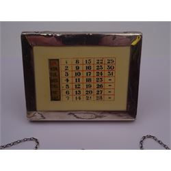 1920s silver mounted perpetual desk calendar, printed in red and black on an ivorine ground, hallmarked Charles S Green & Co Ltd, Birmingham 1925, with wooden easel style support verso, together with a set of three modern silver decanter labels, with cut-out lettering for gin, whisky and vodka, hallmarked London 1982, maker JKM, calendar H8.4cm