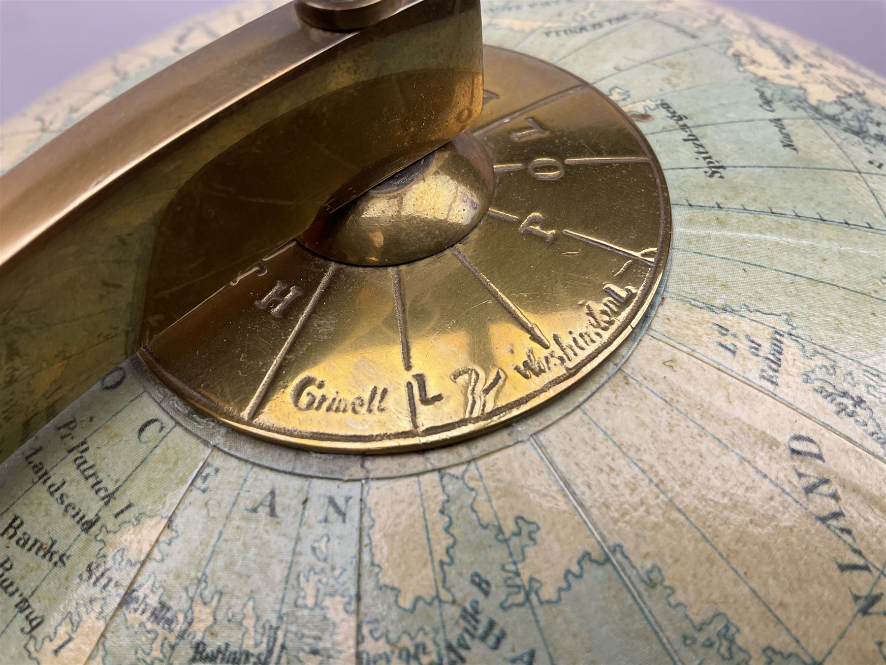 Terrestrial globe by Grinell, Washington, mounted on a brass half meridian and raised on turned wood pedestal base, H55cm