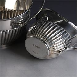 1920s silver three piece tea service, comprising teapot, twin handled open sucrier and milk jug, each of oval part fluted form, the teapot with Bakelite type handle and finial, hallmarked Cooper Brothers & Sons Ltd, Sheffield 1922