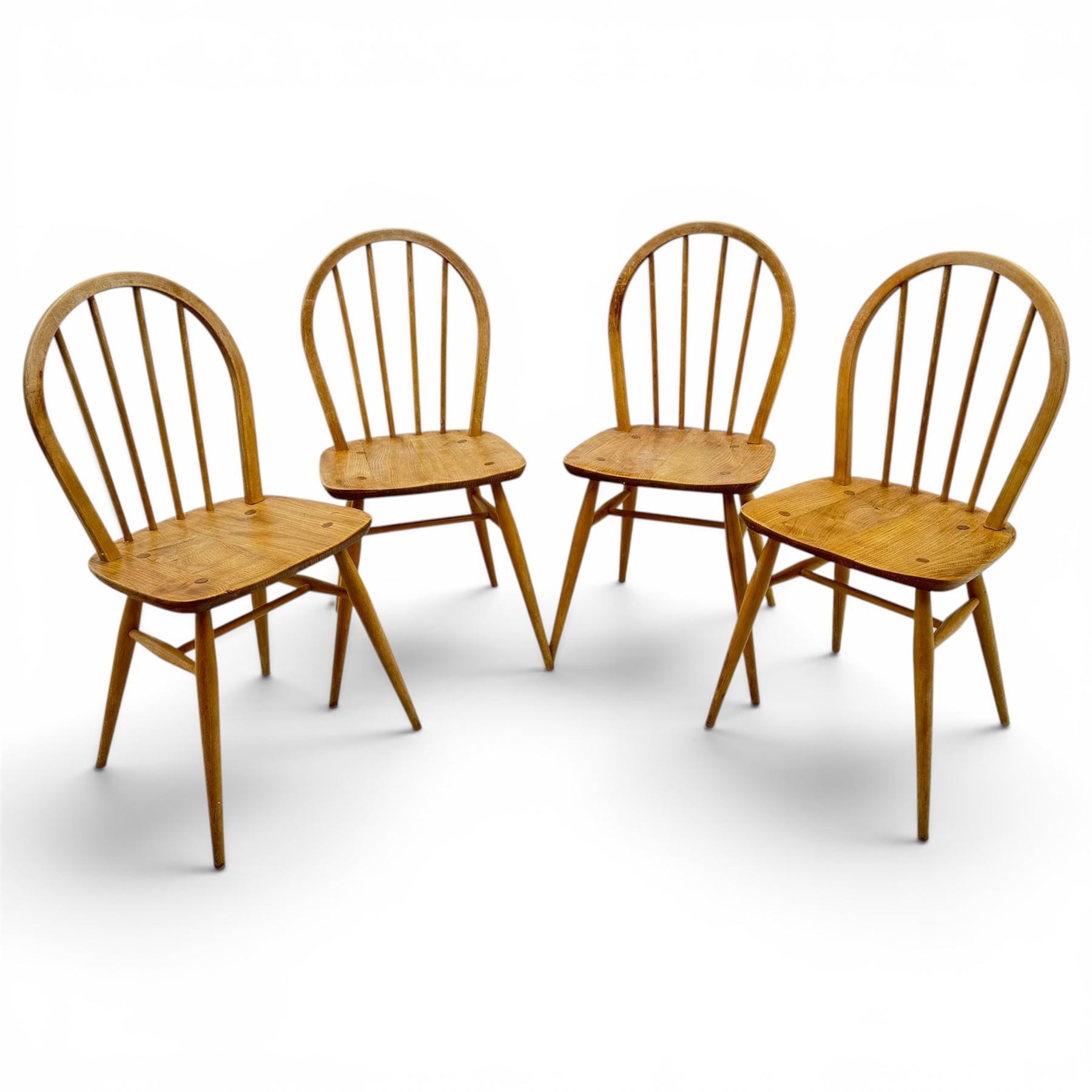 Ercol - set of four elm 'Windsor' chairs, hoop design back dish seat, tapering supports united by H-stretcher 