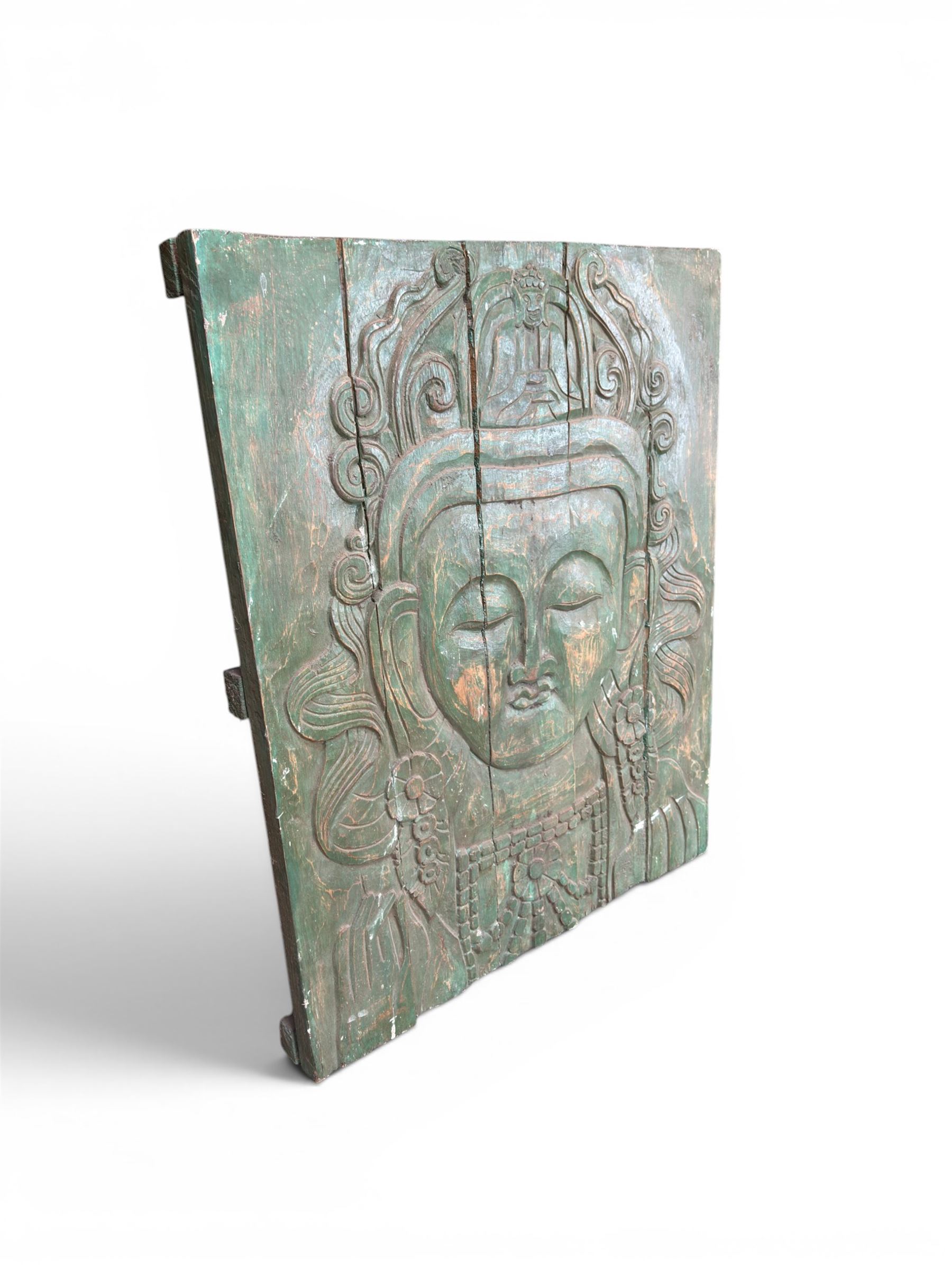 Pair of South East Asian carved wooden panels, depicting Buddha or Deity faces