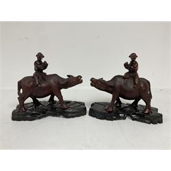 Pair of Chinese hardwood figures of farmers riding water buffalo, on stands, H19cm