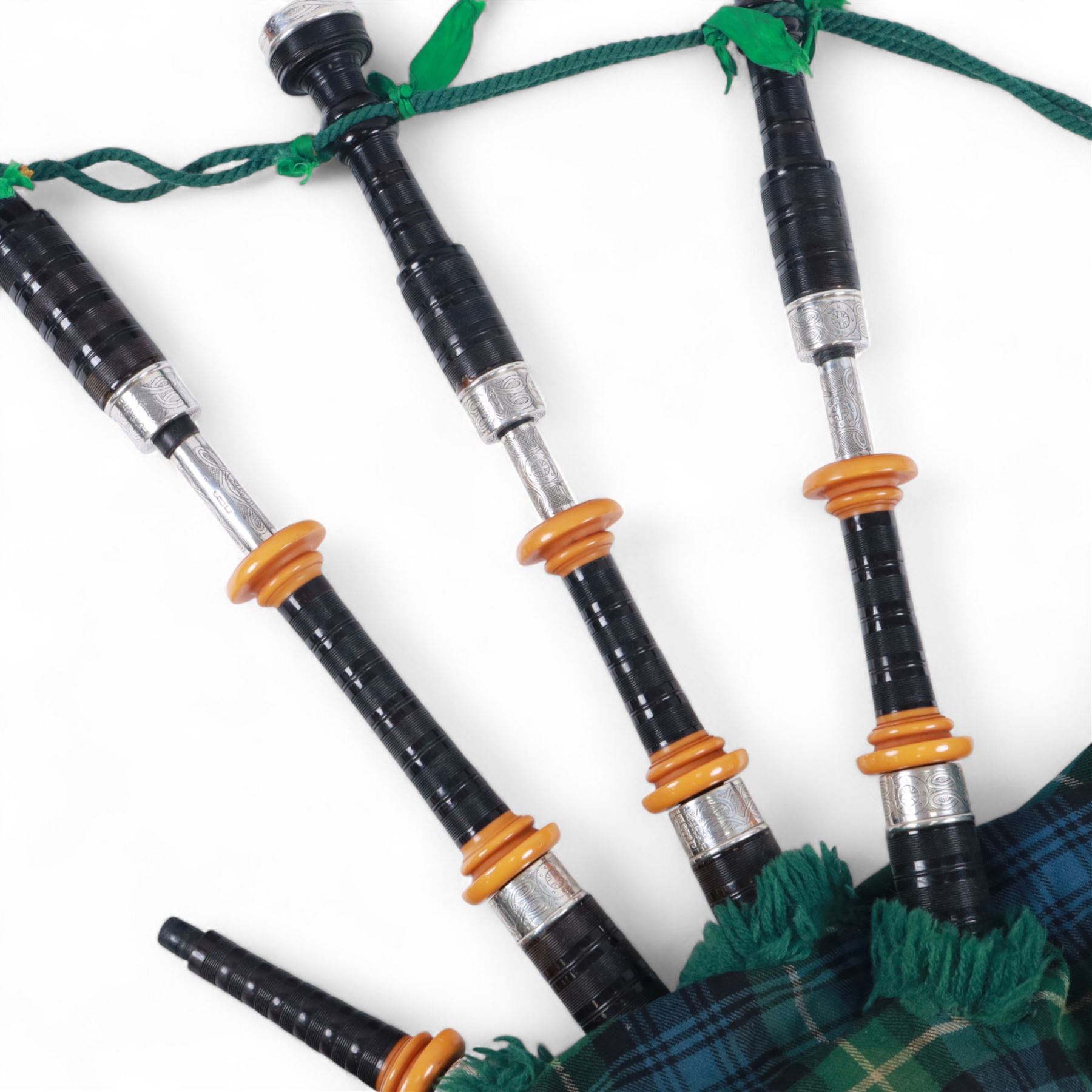 Set of late 20th century silver mounted bagpipes, the turned ebonised hardwood drone rods with Celtic knot and stipple engraved silver collars and ivorine mounts, hallmarked Bernie Leigh, Birmingham 1991, with R.G Hardie Glasgow plastic chanter and bag in green and blue Armstrong tartan, contained within a plush lined hard case, with a collection of spare reeds, drone rods, chanter, bags, cleaning accessories and other accessories 