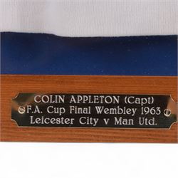 F.A. Cup Final Wembley 1963 Leicester City V Manchester United match worn long sleeved shirt, worn by Colin Appleton Leicester City captain, all white with striped blue collar and cuffs, embroidered cloth Leicester City badge with Wembley 1963 below, with Bukta Dyfast Zeebux label to inner collar, contained within a glazed wooden display frame with engraved plaque reading Colin Appleton (Capt) F.A. Cup Final Wembley 1963 Leicester City V Man Utd, frame H80cm

Notes: The 1963 F.A. Cup final was played on 25 May 1963 at Wembley 'Empire' Stadium. The final was won by Manchester United 3-1. 

Colin Harry Appleton (7 March 1936 – 31 May 2021) was an English footballer and manager. He captained Leicester during their 1962-63 season and the FA Cup final of this year. He then went on to captain them to the 1964 League Cup win. 

He later played for Charlton Athletic and Barrow, before playing for and managing Scarborough. He went on to manage Hull City, Swansea City, Exeter City and Bridlington Town.