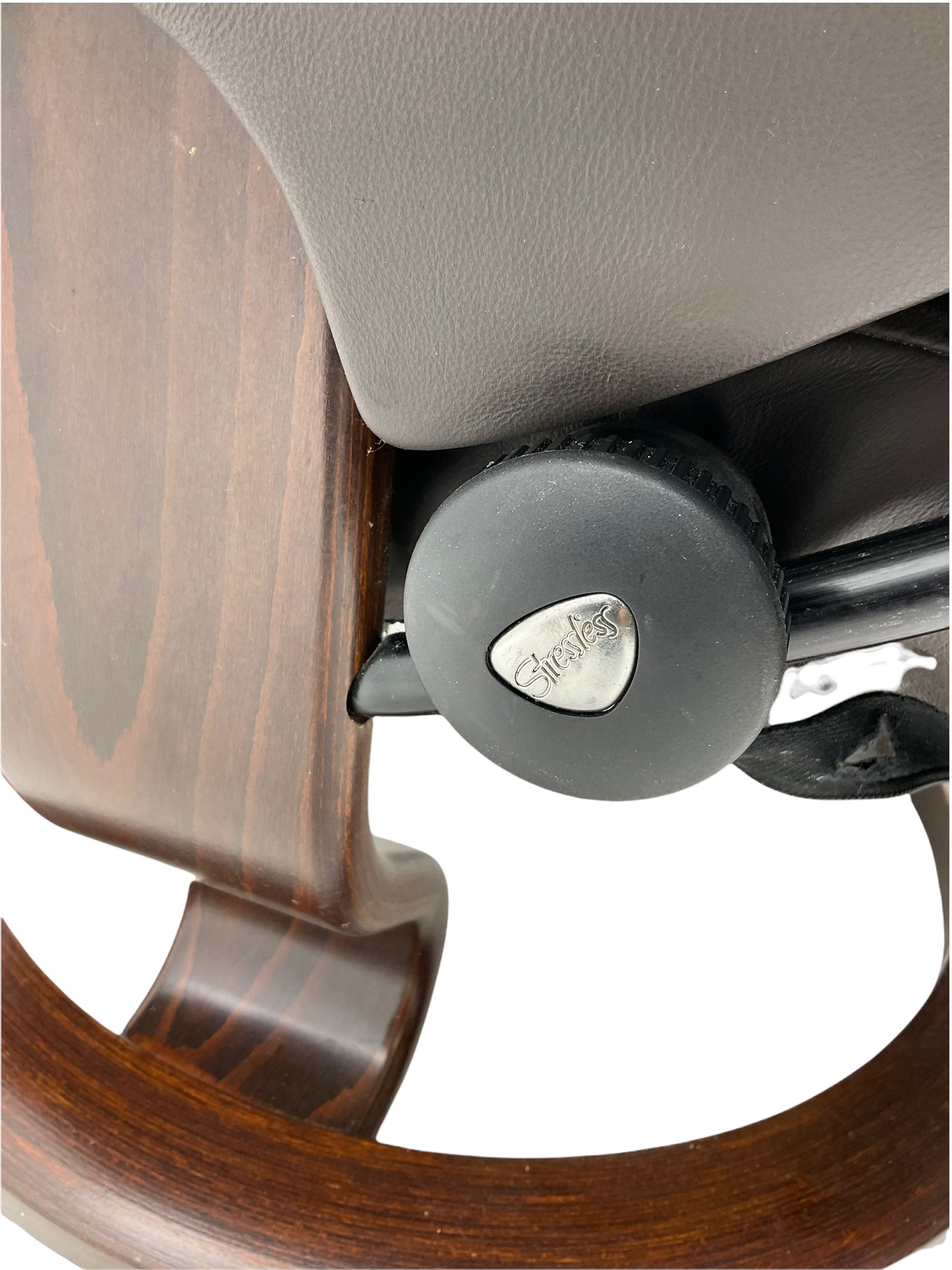 Ekornes Stressless - swivel reclining armchair with adjustable headrest, upholstered in cocoa brown leather, with matching footstool