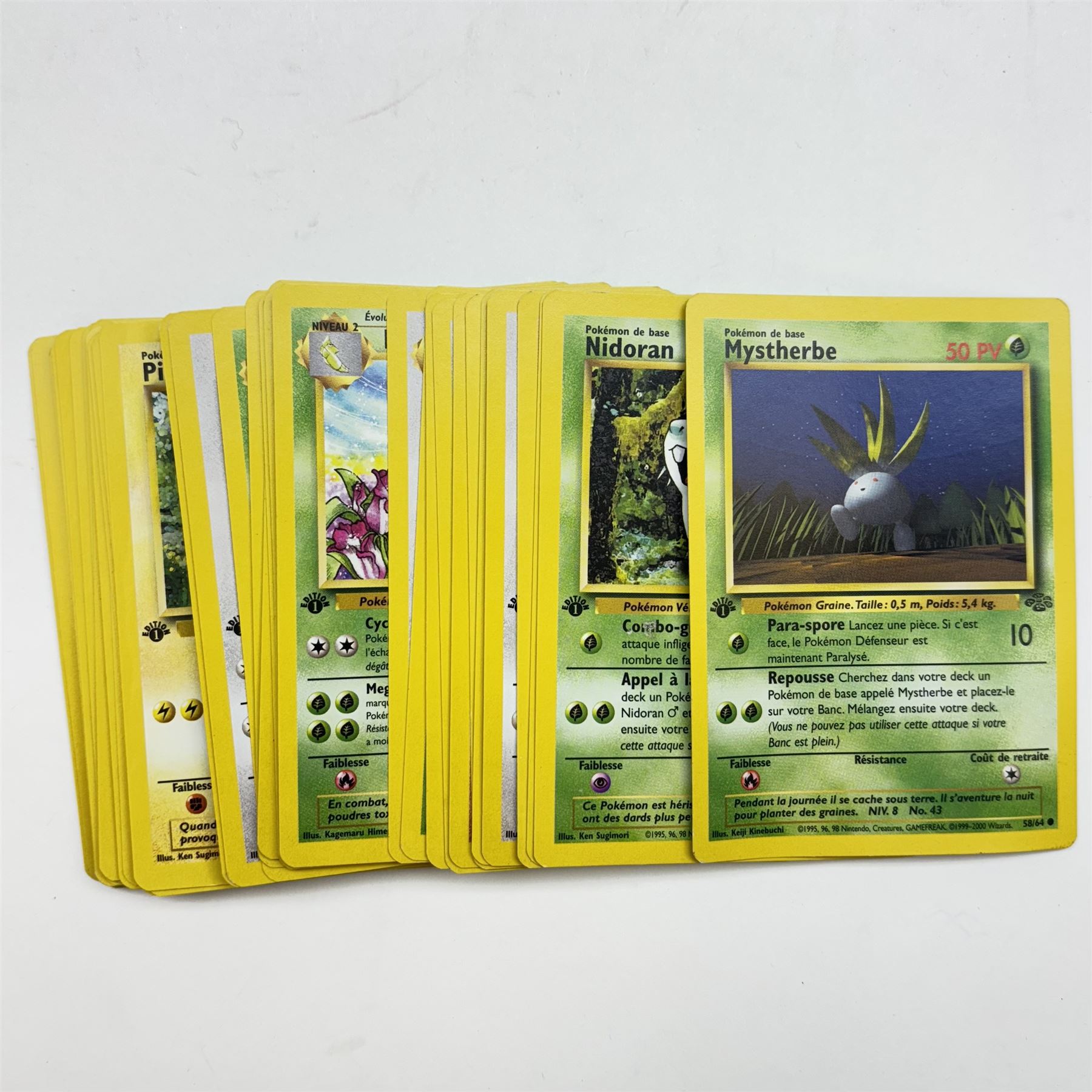 Collection of vintage English and French language Pokemon TCG trading cards, approximately eighty English cards housed in Pokemon file, including Base Set, Base Set 2, Team Rocket, Neo Discovery, Jungle and Fossil examples, with thirteen holos including Charizard 4/102, Dark Blastoise 3/82, Ninetales 12/102, Mewtwo 10/102, and First Edition Machamp 81/102, approximately two hundred French language cards, many first editions, including four first edition holos, Roucarnage 8/64, Nidoqueen 7/64, Melodelfe 1/64 and Mackogneur 8/102, all loose, together with a Funfax Pokemon Collectors File