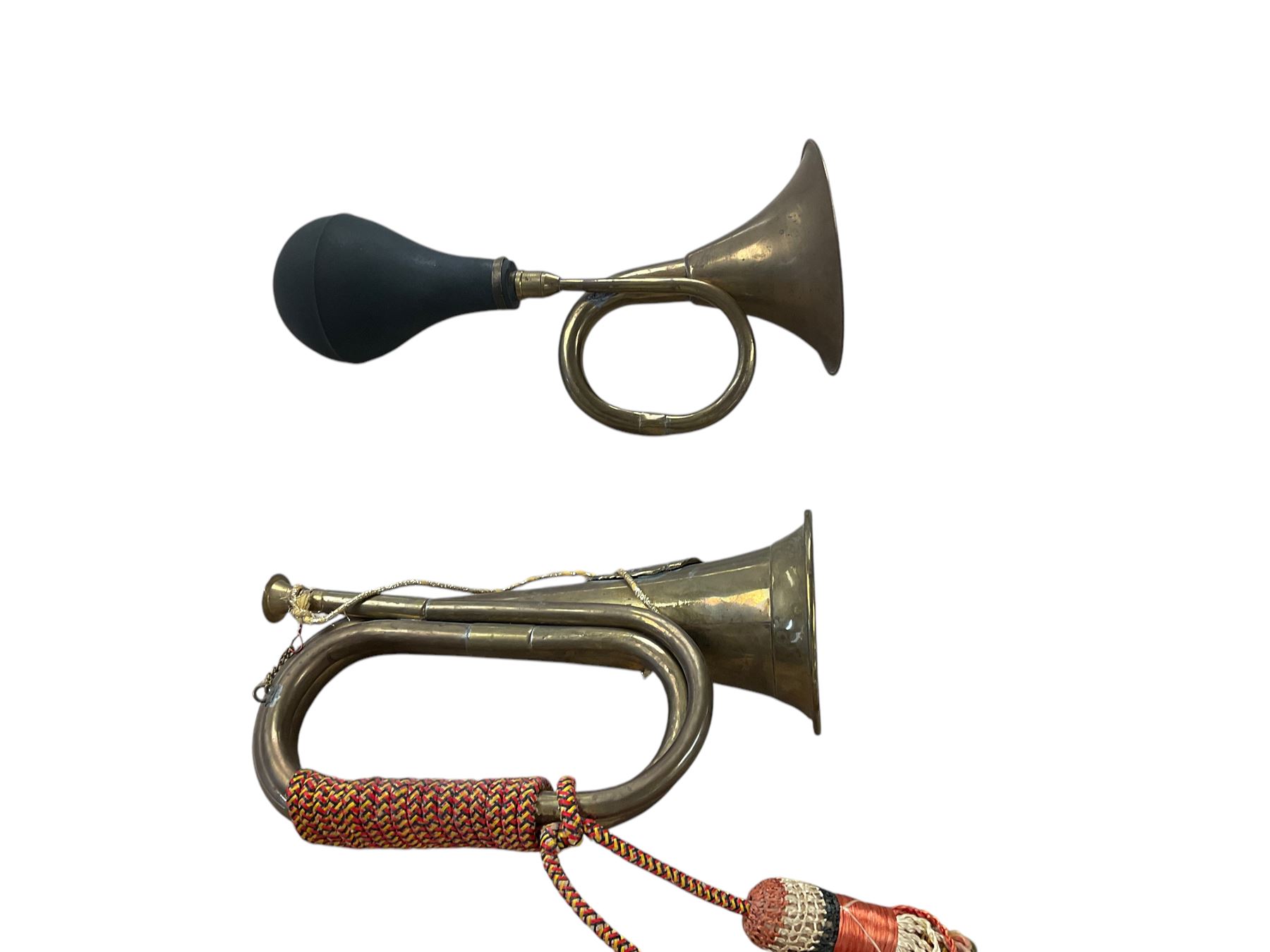 Collection of copper horns, including coaching horns, military bugle etc