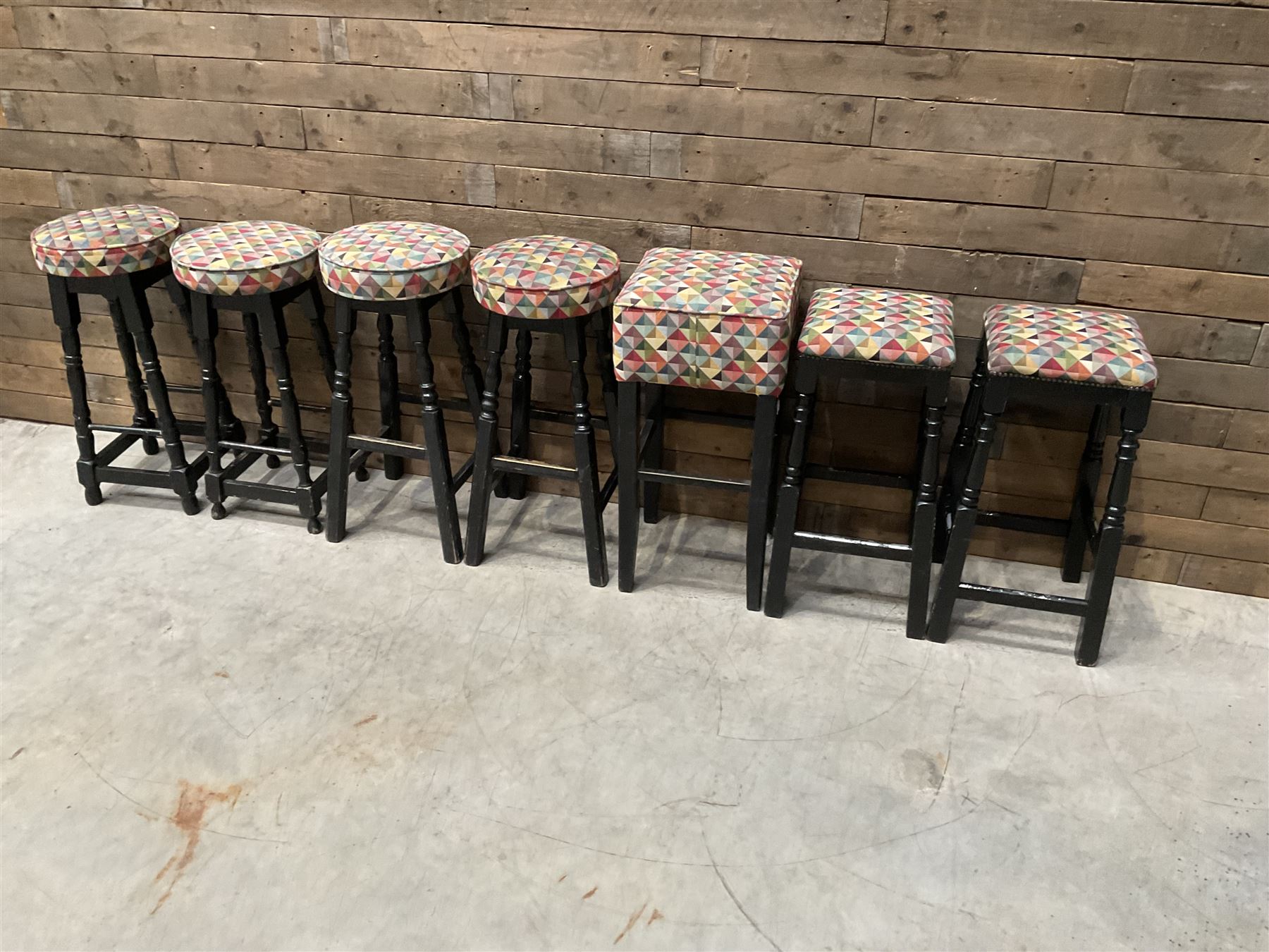 Seven tall bar stools with upholstered seat