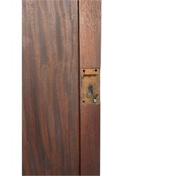 George III mahogany Gentleman's linen press, the projecting cornice over two panelled cupboard doors enclosing three sliding trays, the base fitted with two short over three long graduating cock-beaded drawers, lower moulded edge over bracket feet
