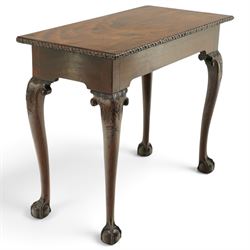 George I carved mahogany side table, adapted from a card table, the rectangular top with foliate-carved edge above a plain frieze, raised on cabriole legs with acanthus-carved knees, volute brackets and floral-carved motifs, terminating to ball-and-claw feet