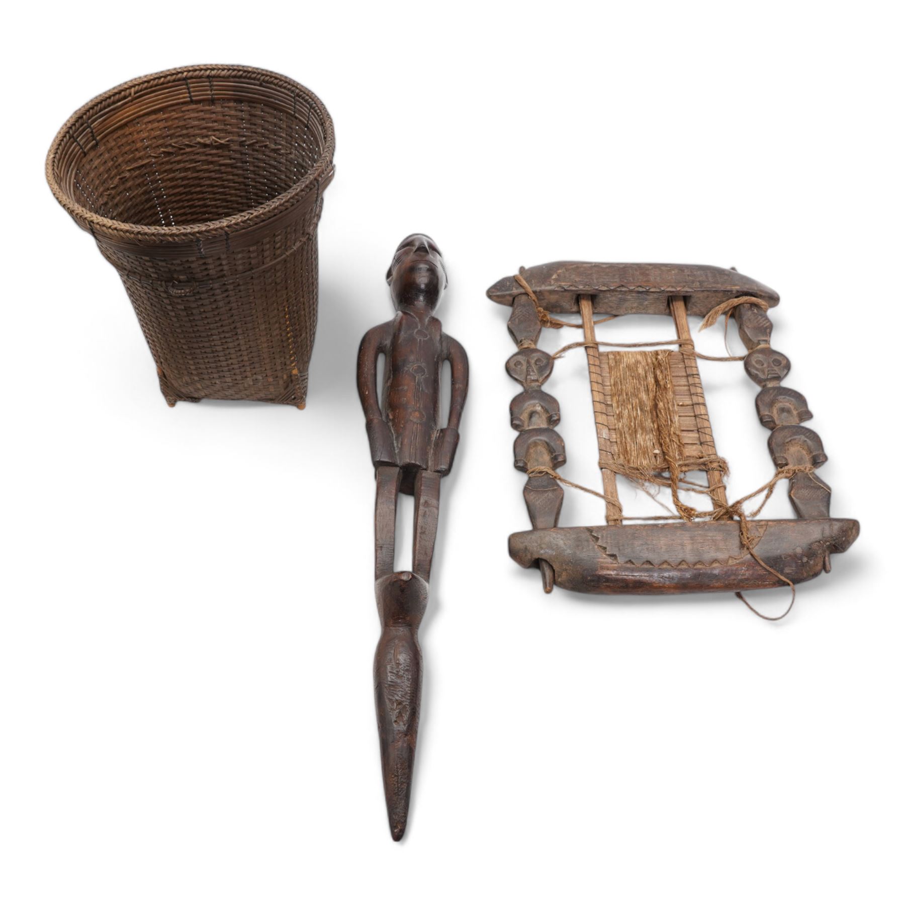 African Colonial carved hardwood staff finial, the male figure in military dress, L66cm, African Fang weaving tool and a woven basket (3)