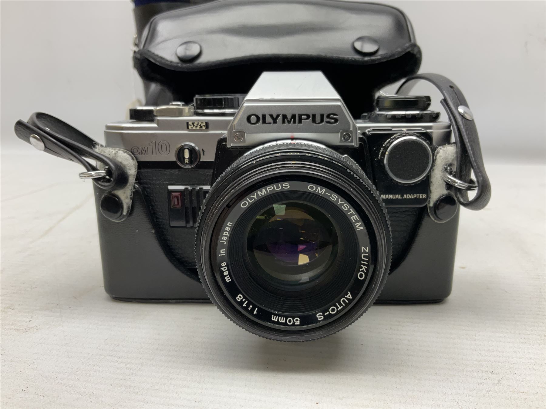 Olympus OM10 35mm camera, cased; pair of USSR 7 x 50 binoculars; cased; and pair of Le Jockey Club Paris binoculars