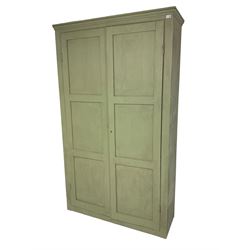 Painted pine cupboard, two panelled doors enclosing four shelves, in laurel green finish