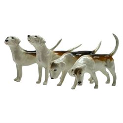 Beswick hunting group, comprising huntsman on bay horse no. 1501, fox figure no. 1440 , and four fox hounds, all with printed marks beneath (6)
