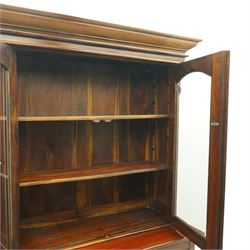 Victorian revival hardwood dresser cabinet, projecting moulded cornice above three glazed doors with shaped tops enclosing shelves, moulded top over three drawers and three panelled cupboard doors, flanked by applied carved brackets, on plinth base