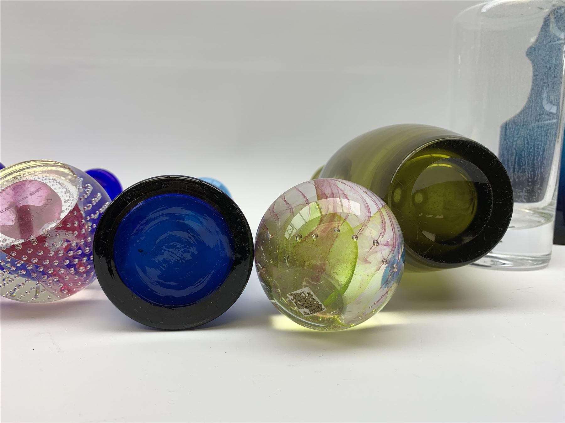 Kosta Boda decanter bottle, c1960, designed by Erik Höglund (1932-1998), in a triangular pressed form, engraved pattern number H1250/250, a clear glass decanter with bubble inclusion, probably Kosta Boda, two Scandinavian glass vases, ochra glass vase, Isle of Wight glass paperweight, Caithness glass paperweight & vase (8)