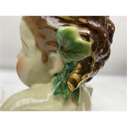 19th century pair of hand painted ceramic busts of children, together with a third similar example of a putti with a crown of ivy, tallest H23cm 