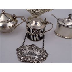 Group of silver, comprising Gin decanter label, embossed with vine leaves, pierced and embossed open salt, and three mustard pots and covers, each with blue glass liners and matched silver spoons, all hallmarked 