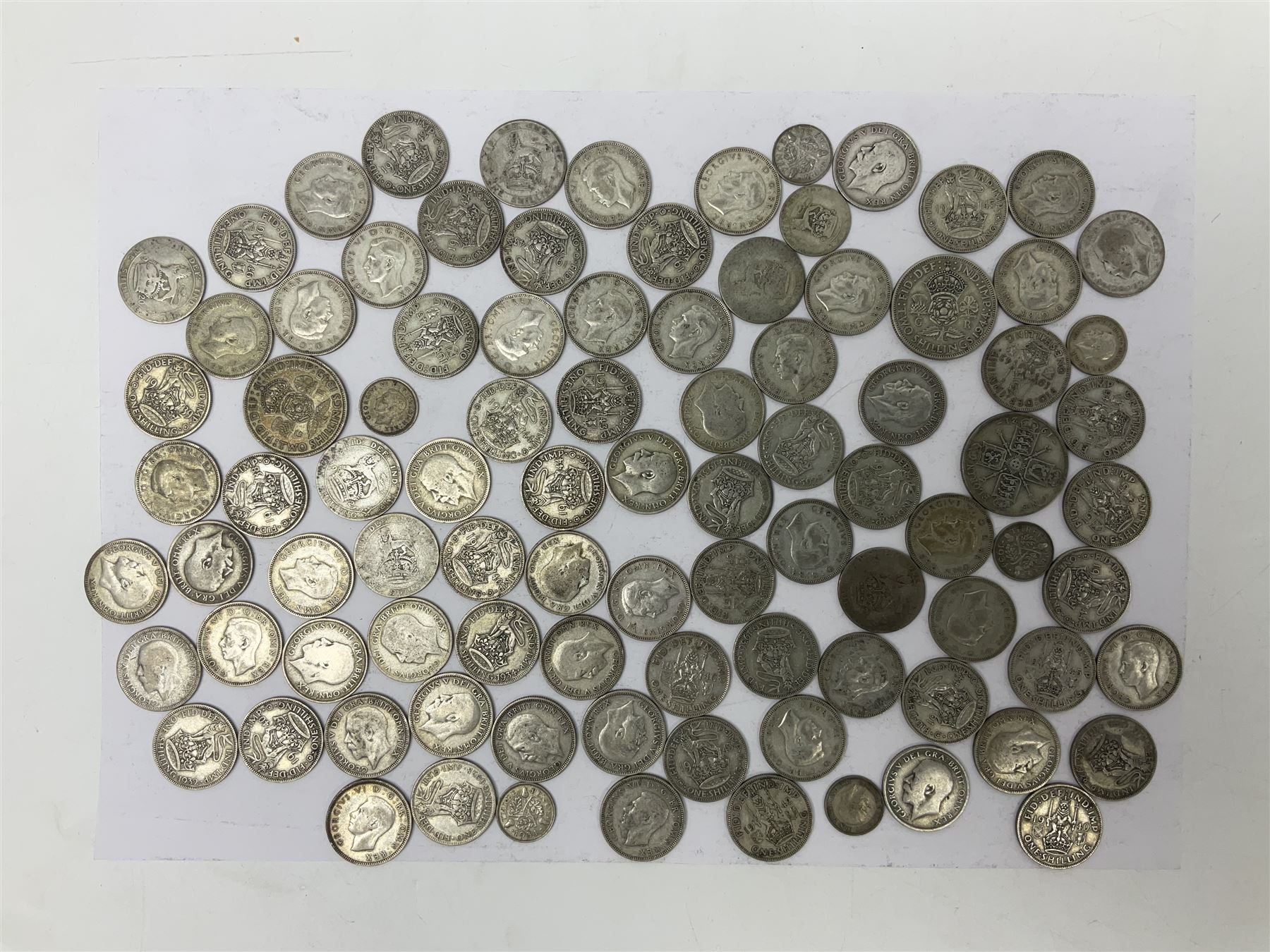 Approximately 500 grams of Great British pre 1947 silver coins, including  two shillings, one shillings and threepence pieces