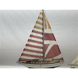 Wooden kit built model yacht with sails and mounted on wooden base, together with a small yacht model, largest example H92cm