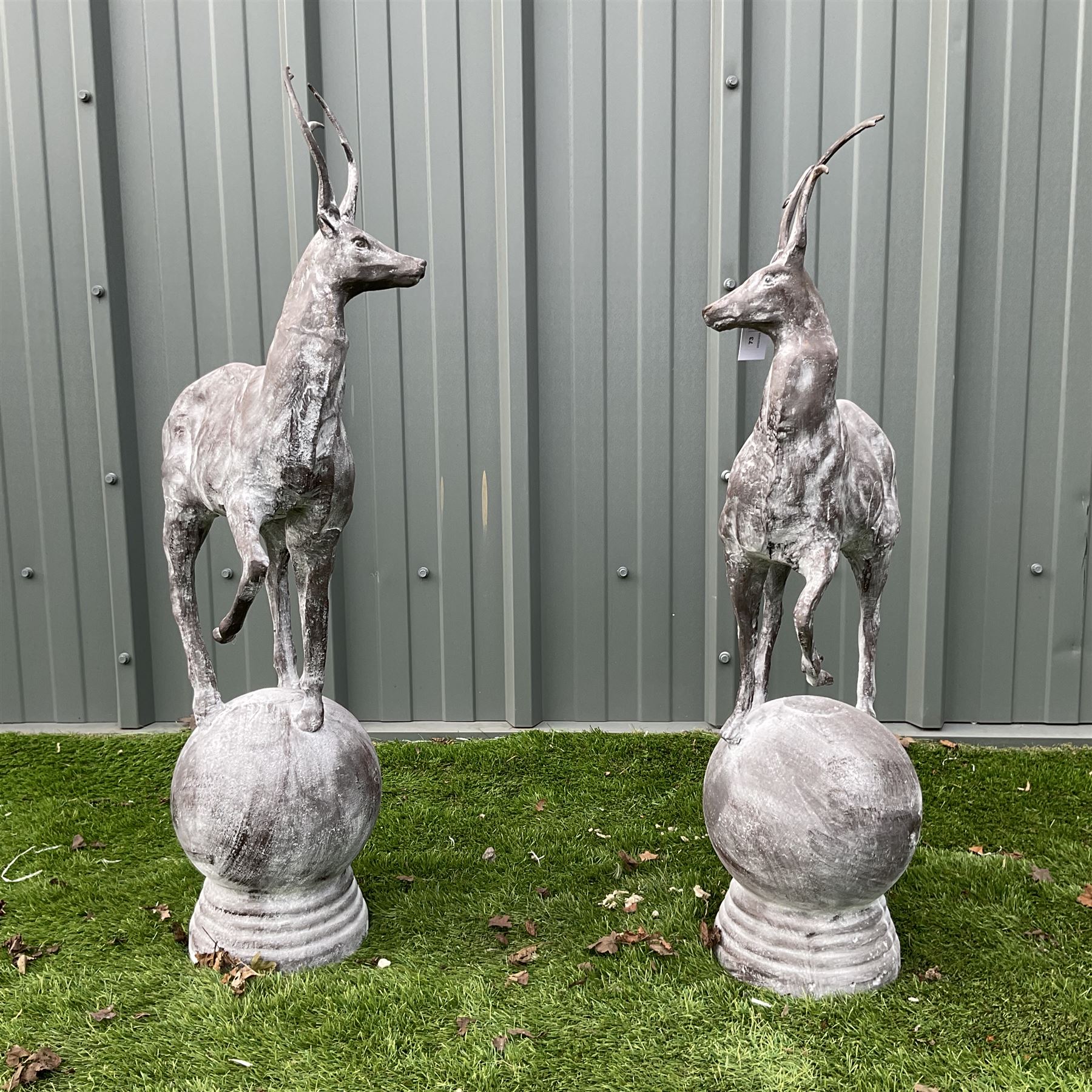 A pair of cast iron garden stag finials on ball bases - THIS LOT IS TO BE COLLECTED BY APPOINTMENT FROM DUGGLEBY STORAGE, GREAT HILL, EASTFIELD, SCARBOROUGH, YO11 3TX