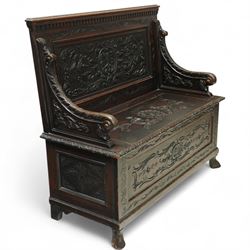 Late Victorian carved oak hall bench, the panelled back deeply carved with scrolling acanthus and central cartouche, hinged seat with foliate and shell motifs, scroll carved arm supports, on short cabriole front legs