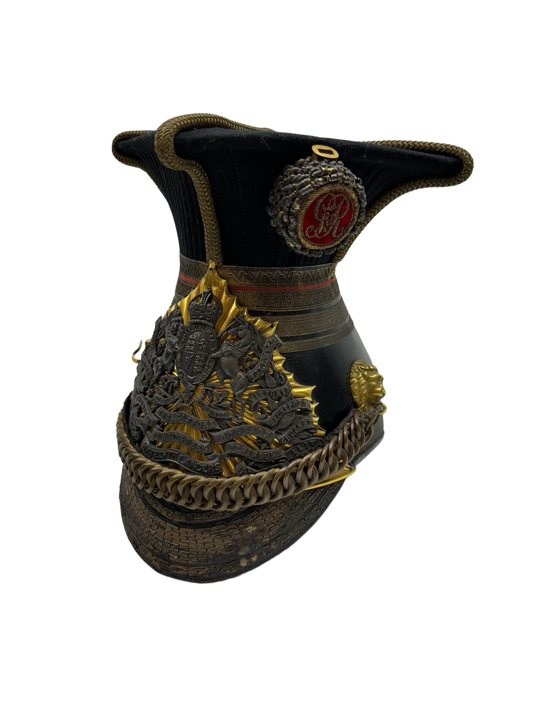 16th Queens Lancers Officers Lance Cap, black leather body with gilt braid lace and gilt wire braiding to the peak, officers silver gilt helmet plate to the front, the black cloth mortar board top with thick bullion wire, the bullion socket holder with embroidered GR cipher to the centre, lion head side bosses with velvet backed linked chinstrap, interior with leather sweatband and cloth lining, marked Carter & Co Pall Mall, the helmet is housed in japanned storage tin with brass plaque engraved “Lieu H L Evans, 16th Lancers'