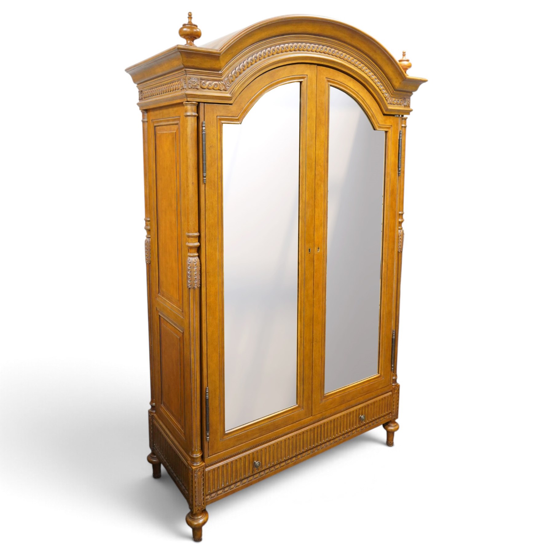 And So To Bed - French design ‘Eclectic’ double wardrobe in light finish, arched moulded cornice with carved foliate band and turned finials, two mirrored doors enclosing a hanging rail, flanked by turned columns with foliate decoration, single fluted drawer below, on turned tapering feet