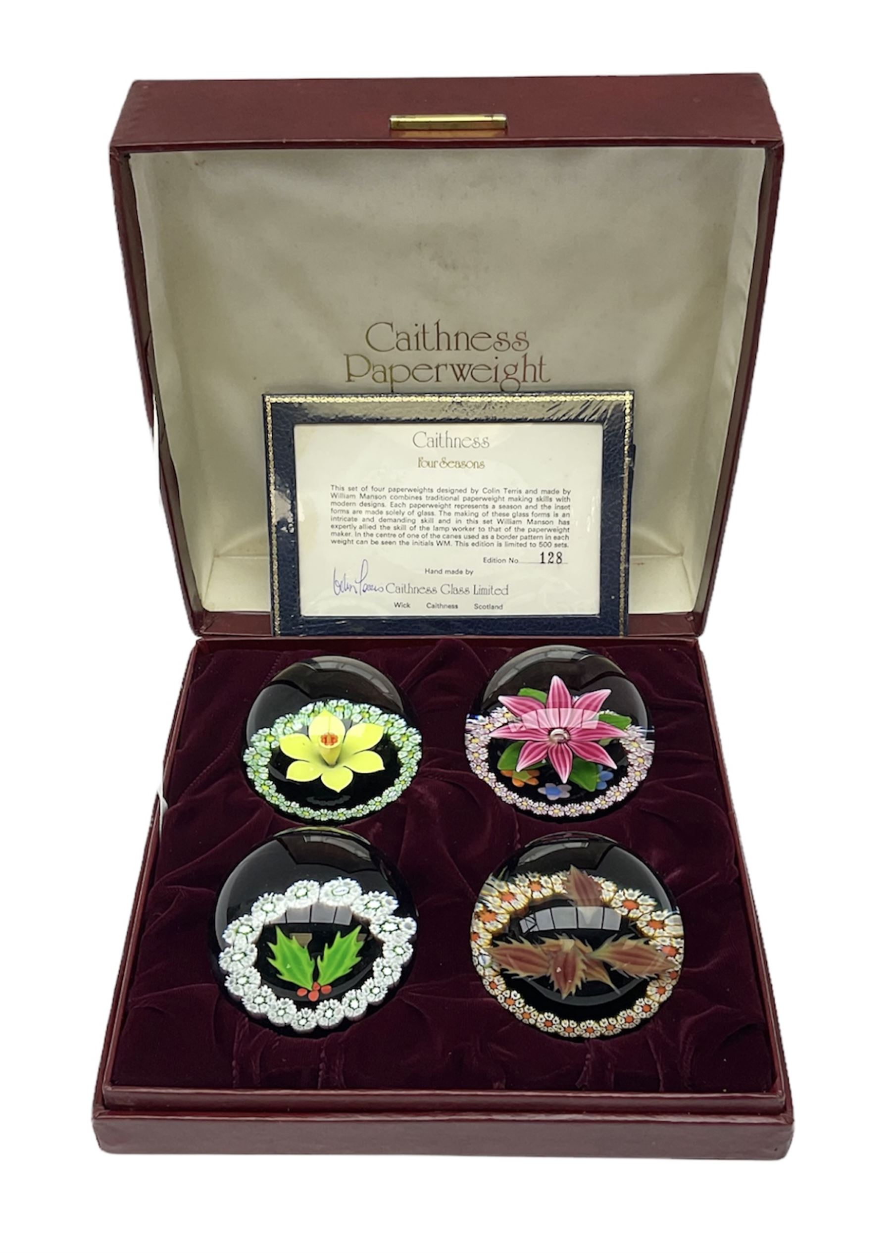 Set of four Caithness paperweights titled Four Seasons, in presentation box with certificate, designed by Colin Terris and made by William Mason, each internally decorated with a seasonal flower within a millefiori cane work garland, numbered 128 of 500