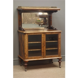  Victorian Burr walnut music cabinet, brass galleried top on scroll supports above a mirror, and two glazed doors enclosing two titled shelves all outlined with key banding, on turned supports with brass beaded sockets and castors, W68cm, H106cm, D43cm  