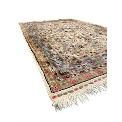 Persian design ivory ground rug, overall floral design with shaped central medallion, the main border decorated with trailing flower head pattern, within guard stipes 