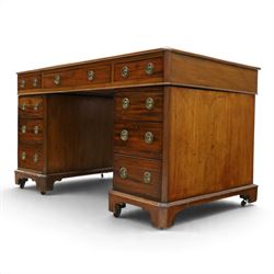 Late Victorian mahogany desk with red leather top, rectangular top with inset toold red leather writing surface, central long frieze drawer flanked by two short drawers, above pedestal with three graduating drawers with ring pull handles, on moulded plinth bases raised on castors